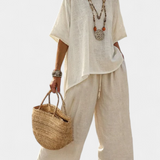 Completely minimalist Daisy in natural shades, with a ruffle blouse and wide-leg trousers for a simple and elegant style.