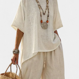 Completely minimalist Daisy in natural shades, with a ruffle blouse and wide-leg trousers for a simple and elegant style.